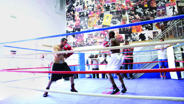A group of boxers competing in round 10 of a boxing match.