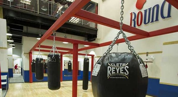A Round 10 Boxing gym with a boxing bag hanging from the ceiling.