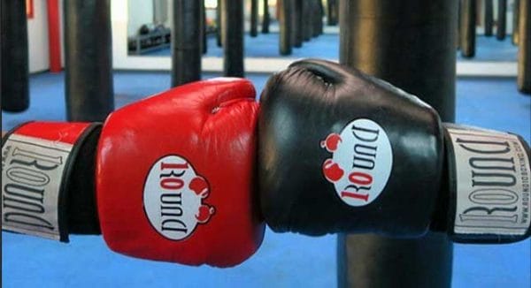 A pair of red and black Round 10 boxing gloves.